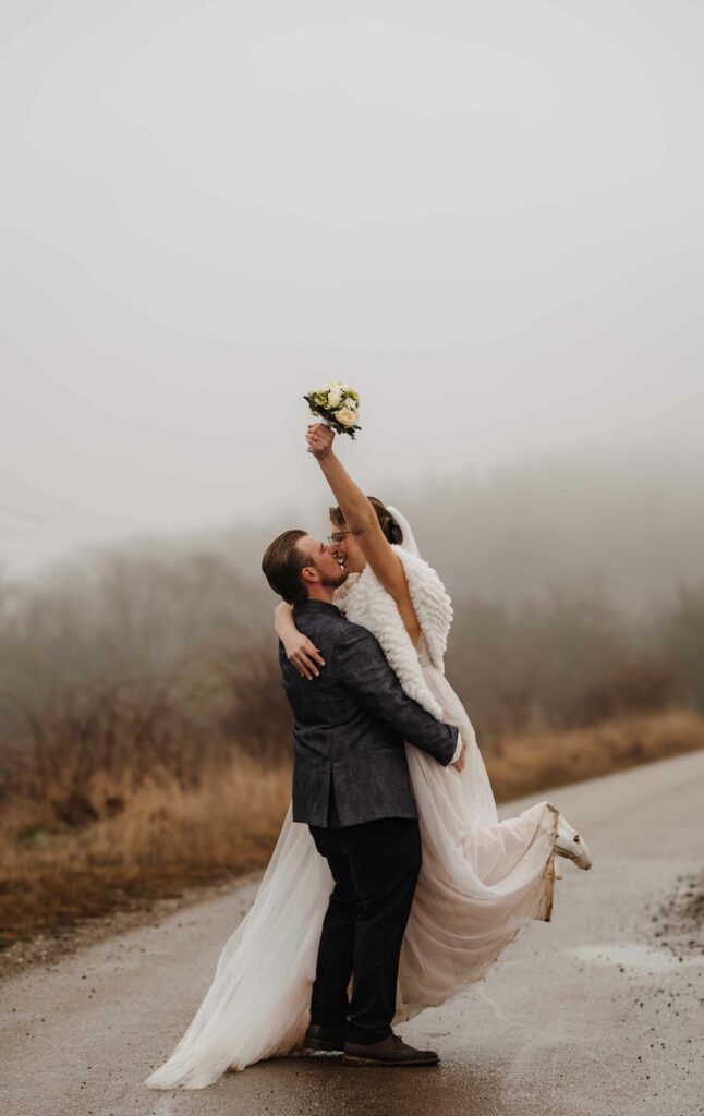 Braut wirft den Brautstrauß in die Luft, Winterhochzeit im Nebel – Sabrina Dötzl Fotografie Hollabrunn